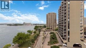 Sarnia condo for rent - A view of a cityscape with a body of water and buildings.