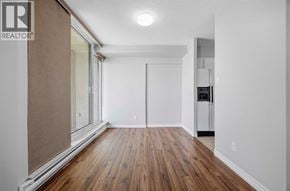 Sarnia condo for rent - A room with wooden floors and white walls.