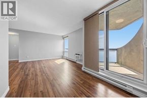 Sarnia condo for rent - A room with wooden floors and a sliding glass door.