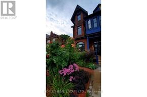 Toronto (Dufferin Grove) fourplex for rent - A real estate company's brochure featuring a charming house with a well-kept garden.