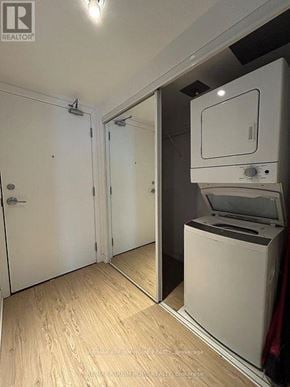 Toronto (Church-Yonge Corridor) condo for rent - A white washing machine is in a small laundry room.