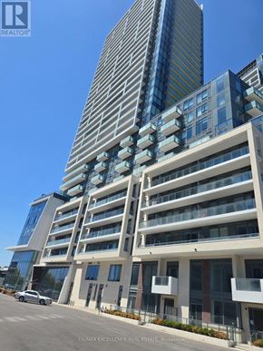 Toronto (Newtonbrook East) condo for rent - A tall building with a glass facade stands next to a shorter building with a white facade.
