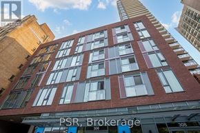 Toronto (Church-Yonge Corridor) house for rent - A tall red brick building with the words PSR Brokerage on the front.
