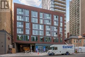 Toronto (Church-Yonge Corridor) house for rent - A Canpar delivery truck is parked in front of a multi-story building.