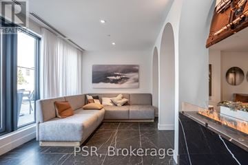 Toronto (Church-Yonge Corridor) house for rent - A modern living room with a grey sofa and a large painting on the wall.