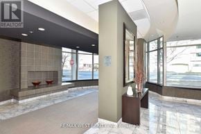 Toronto (Clanton Park) condo for rent - A lobby with a large marble floor and a reception desk.