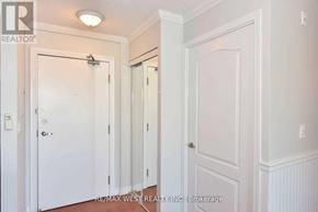Toronto (Clanton Park) condo for rent - A hallway with white doors and a brokerage sign.