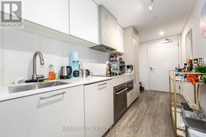 Toronto (Niagara) condo for rent - A kitchen with white cabinets and a sink.
