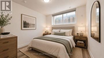 Toronto (Willowdale West) townhouse for rent - A well-lit bedroom with a large bed and a framed picture on the wall.
