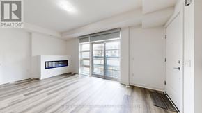 Toronto (Willowdale West) townhouse for rent - A spacious room with a large window and sliding glass doors.