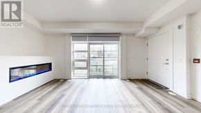 Toronto (Willowdale West) townhouse for rent - A spacious room with a large window and a wooden floor.
