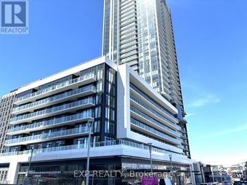Toronto (Banbury-Don Mills) condo for rent - A tall building with a glass facade and a sign that reads "EXPREALTY Brokerage.".