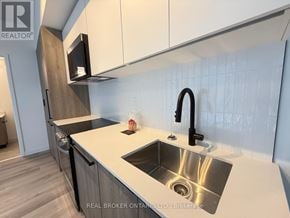 Toronto (Centennial Scarborough) condo for rent - A modern kitchen with a sink and a microwave above it.