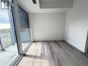 Toronto (Centennial Scarborough) condo for rent - A room with a large window and wooden flooring.
