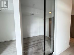 Toronto (Centennial Scarborough) condo for rent - A room with a glass door and wooden flooring.
