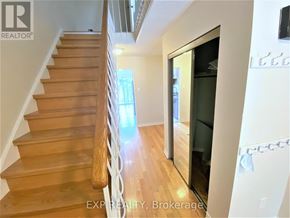 Toronto (Agincourt North) townhouse for rent - A wooden staircase with a glass door leading to a balcony.