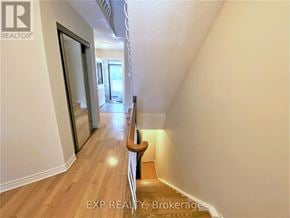 Toronto (Agincourt North) townhouse for rent - A hallway with wooden floors and white walls.