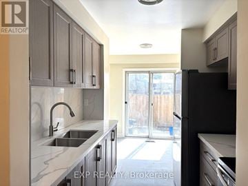 Toronto (Agincourt North) townhouse for rent - A kitchen with a sink and a refrigerator.