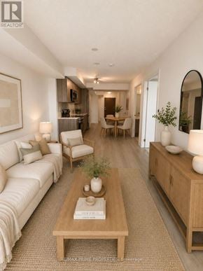 Pickering (Bay Ridges) condo for rent - A well-lit, modern living room with a white sofa, wooden coffee table, and a dining area in the background.