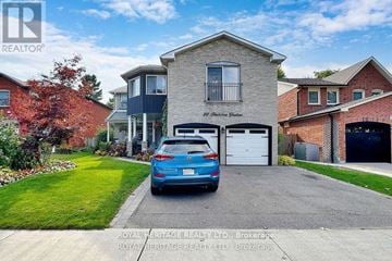 Toronto (Rouge) apartment for rent - A blue car is parked in front of a two-story house.