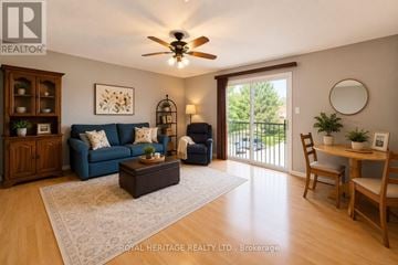 Toronto (Rouge) apartment for rent - A living room with a blue couch and a wooden floor.