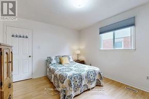Toronto (Rouge) apartment for rent - A bedroom with a patterned bedspread and a window with blinds.