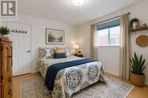 Toronto (Rouge) apartment for rent - A bedroom with a bed covered in a blue and white patterned bedspread.