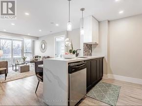 Pickering (Town Centre) condo for rent - A modern kitchen with a large island and a dining area.