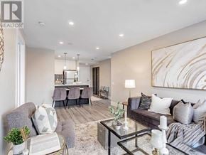 Pickering (Town Centre) condo for rent - A modern living room with a grey sofa, a glass coffee table, and a large abstract painting on the wall.