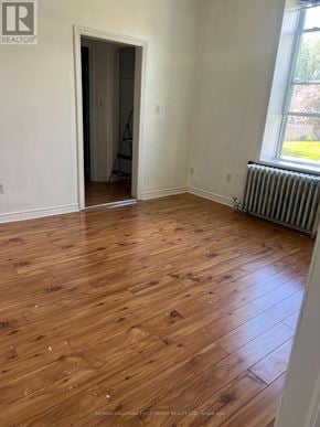 Oshawa (Lakeview) multi-family for rent - A room with wooden flooring and a window with a view of a lawn.