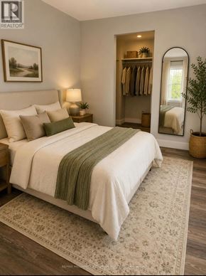 Oshawa (Lakeview) multi-family for rent - A bedroom with a large bed and a mirror on the wall.