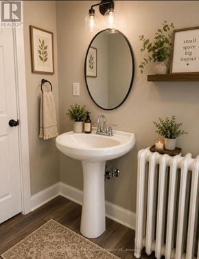 Oshawa (Lakeview) multi-family for rent - A bathroom with a white pedestal sink and a white radiator.