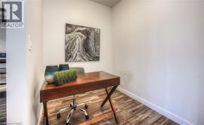 Waterloo condo for rent - A room with a wooden desk and a painting on the wall.