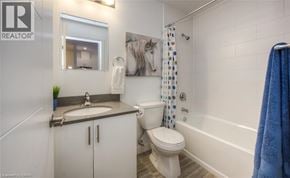 Waterloo condo for rent - A bathroom with a toilet, sink, and shower.