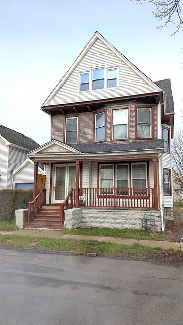 Buffalo apartment for rent - A two-story house with a brown front porch.