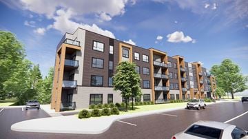 Edmonton apartment for rent - A modern apartment building with a parking lot in front.