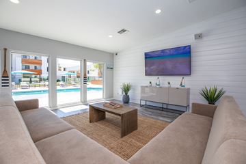 Tempe apartment for rent - A living room with a large couch and a flat screen TV mounted on the wall.