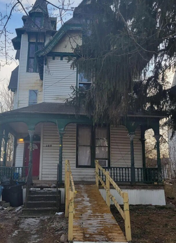 Mansfield apartment for rent - A white house with a red door and a porch.