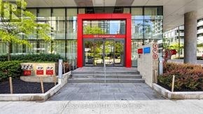 Toronto (Mount Pleasant West) condo for rent - The entrance to a building with a red door and a glass wall on the left side.