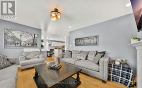 Amaranth apartment for rent - A living room with a grey couch, a coffee table, and a painting on the wall.