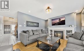 Amaranth apartment for rent - A living room with a grey couch, a coffee table, and a fireplace.