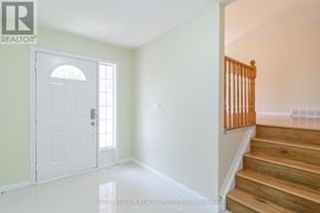 Cambridge apartment for rent - A room with a white door and wooden stairs.
