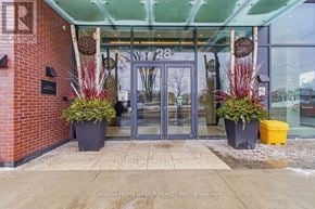 Mississauga (Port Credit) condo for rent - The entrance to a building with a glass door and a number 28 on it.