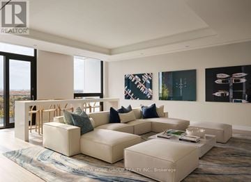 Mississauga (Port Credit) condo for rent - A living room with a large sectional sofa and a coffee table.