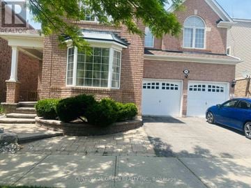Milton (Co Coates) apartment for rent - A blue car is parked in front of a brick house with a white garage door.