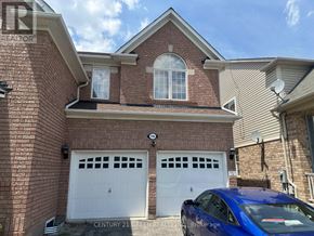 Milton (Co Coates) apartment for rent - A blue car is parked in front of a brick house with two white garage doors.