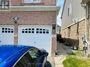 Milton (Co Coates) apartment for rent - A blue car is parked in front of a brick house with a white garage door.