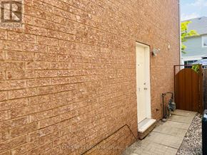 Milton (Co Coates) apartment for rent - A brick wall with a door and a small step leading to it.