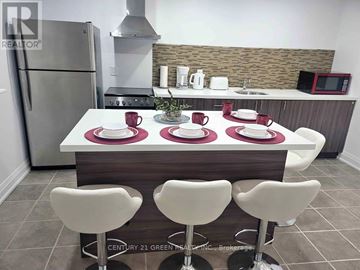 Milton (Co Coates) apartment for rent - A kitchen with a white table and chairs.