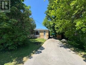 Richmond Hill (Crosby) apartment for rent - A house is surrounded by greenery and a dirt road leads to the front door.